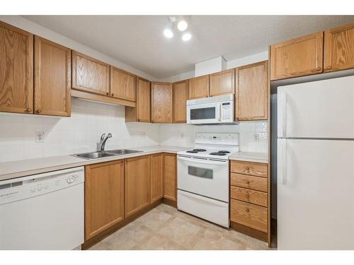 2103-928 Arbour Lake Road Nw, Calgary, AB - Indoor Photo Showing Kitchen With Double Sink