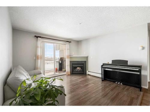 3314-1620 70 Street Se, Calgary, AB - Indoor Photo Showing Living Room With Fireplace