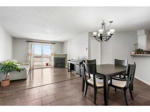 3314-1620 70 Street Se, Calgary, AB - Indoor Photo Showing Dining Room With Fireplace