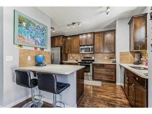 78 Heritage Landing, Cochrane, AB - Indoor Photo Showing Kitchen With Double Sink With Upgraded Kitchen