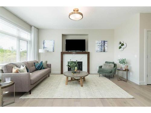 44 Emberside Green, Cochrane, AB - Indoor Photo Showing Living Room With Fireplace