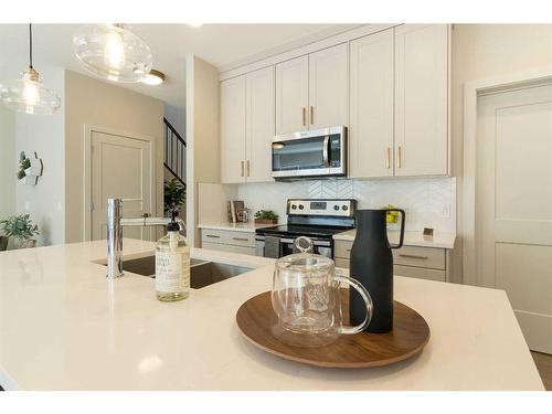 44 Emberside Green, Cochrane, AB - Indoor Photo Showing Kitchen With Double Sink With Upgraded Kitchen