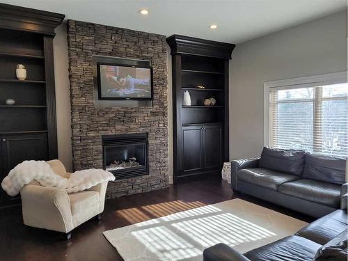 116 Posthill Drive Sw, Calgary, AB - Indoor Photo Showing Living Room With Fireplace