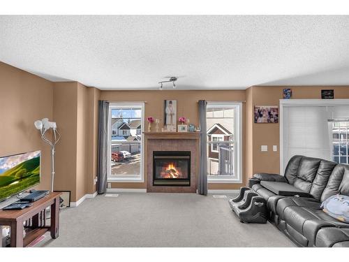150 Hidden Creek Gardens Nw, Calgary, AB - Indoor Photo Showing Living Room With Fireplace