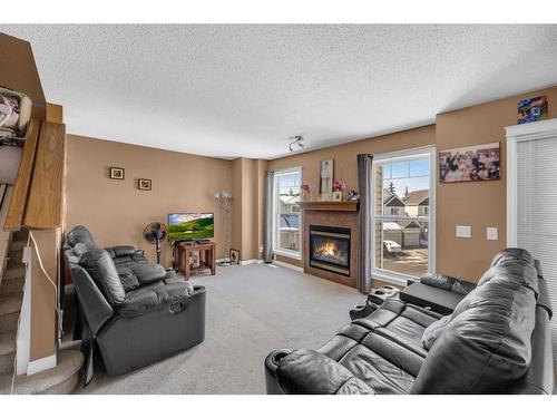 150 Hidden Creek Gardens Nw, Calgary, AB - Indoor Photo Showing Living Room With Fireplace