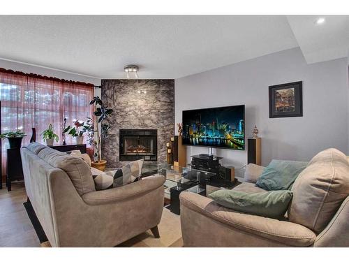 239 Douglasbank Drive Se, Calgary, AB - Indoor Photo Showing Living Room With Fireplace
