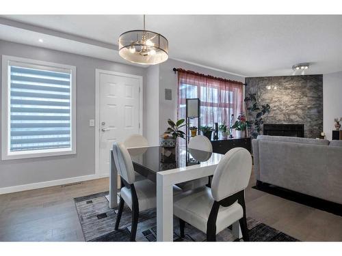 239 Douglasbank Drive Se, Calgary, AB - Indoor Photo Showing Dining Room With Fireplace