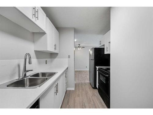 12-3911 1 Street Ne, Calgary, AB - Indoor Photo Showing Kitchen With Double Sink