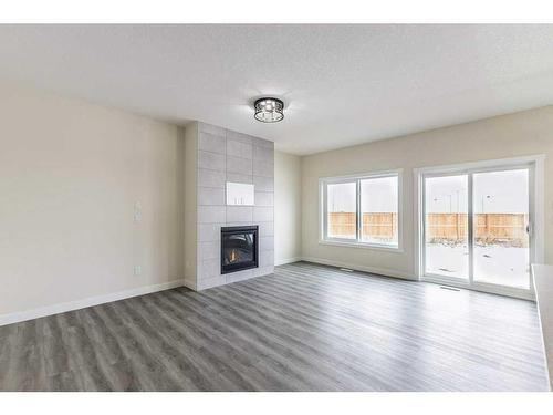 513 Corner Meadows Way Ne, Calgary, AB - Indoor Photo Showing Living Room With Fireplace