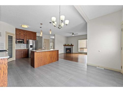 223 Saddlecreek Court Ne, Calgary, AB - Indoor Photo Showing Kitchen With Fireplace With Stainless Steel Kitchen