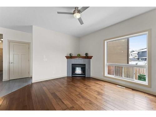 223 Saddlecreek Court Ne, Calgary, AB - Indoor Photo Showing Living Room With Fireplace