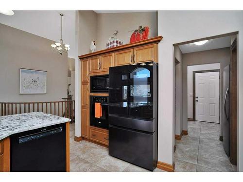 105 Park Meadows Place, Olds, AB - Indoor Photo Showing Dining Room With Fireplace