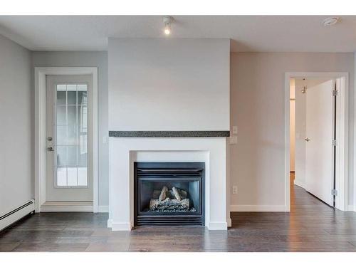 429-35 Richard Court Sw, Calgary, AB - Indoor Photo Showing Living Room With Fireplace