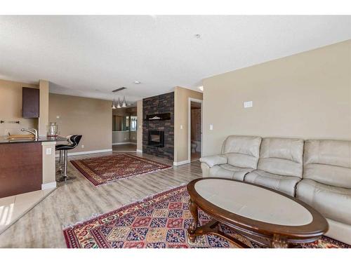 202-195 Kincora Glen Road Nw, Calgary, AB - Indoor Photo Showing Living Room With Fireplace