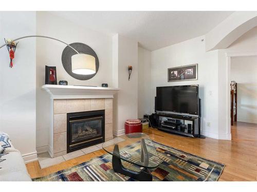 205-4 14 Street Nw, Calgary, AB - Indoor Photo Showing Living Room With Fireplace