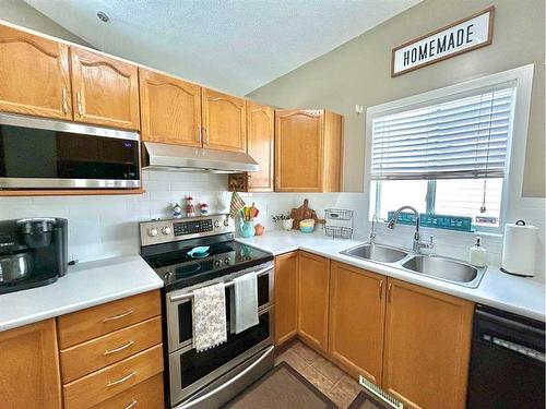 11 Erin Link Se, Calgary, AB - Indoor Photo Showing Kitchen With Double Sink