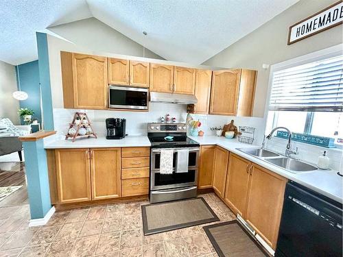 11 Erin Link Se, Calgary, AB - Indoor Photo Showing Kitchen With Double Sink