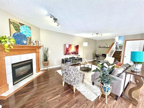 11 Erin Link Se, Calgary, AB - Indoor Photo Showing Living Room With Fireplace