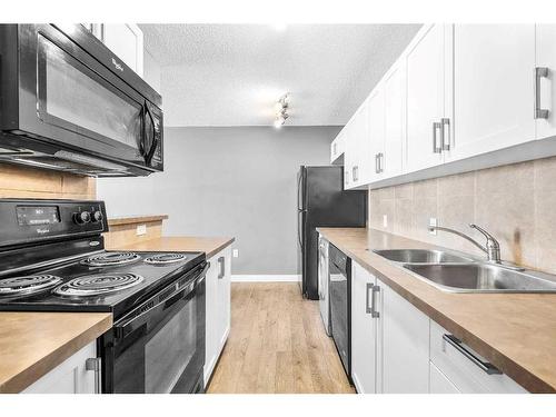 105-110 24 Avenue Sw, Calgary, AB - Indoor Photo Showing Kitchen With Double Sink