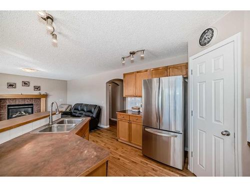 291 Evanston View Nw, Calgary, AB - Indoor Photo Showing Kitchen With Fireplace With Double Sink