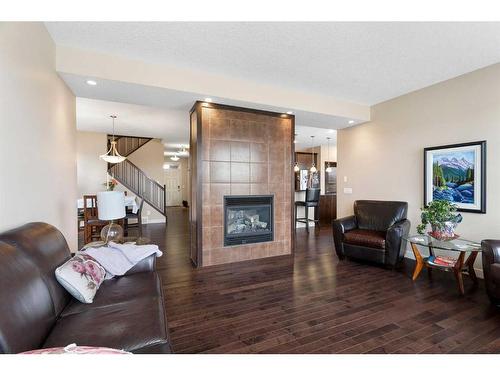 405 Boulder Creek Way Se, Langdon, AB - Indoor Photo Showing Living Room With Fireplace