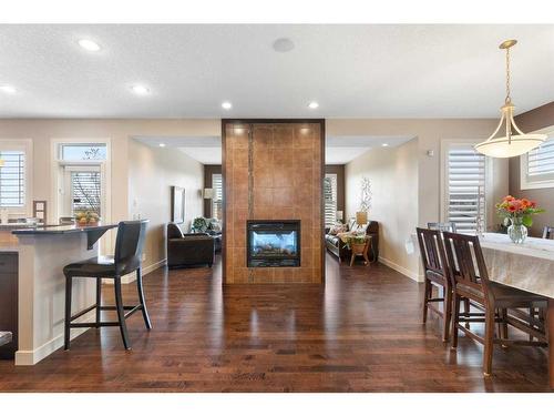 405 Boulder Creek Way Se, Langdon, AB - Indoor Photo Showing Dining Room With Fireplace