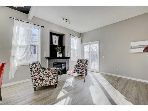 67 Prestwick Gardens Se, Calgary, AB - Indoor Photo Showing Living Room With Fireplace