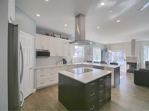 262 Chaparral Court Se, Calgary, AB - Indoor Photo Showing Kitchen With Fireplace With Double Sink