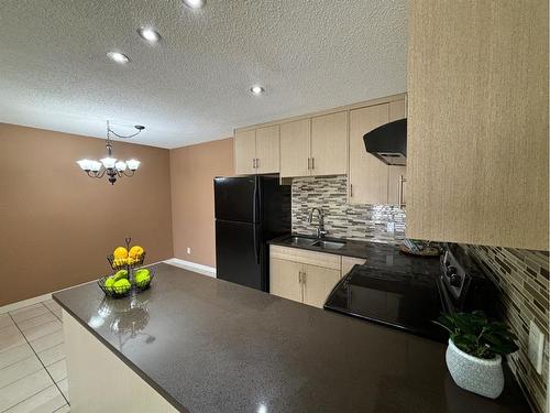 24-2000 Edenwold Heights Nw, Calgary, AB - Indoor Photo Showing Kitchen With Double Sink