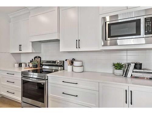 15 Drake Landing Square, Okotoks, AB - Indoor Photo Showing Kitchen With Upgraded Kitchen