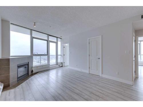 2303-77 Spruce Place Sw, Calgary, AB - Indoor With Fireplace