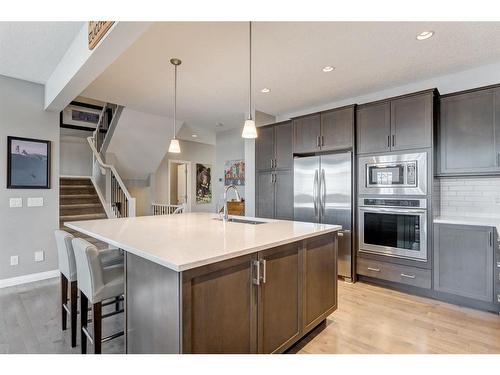 14 Riviera Way, Cochrane, AB - Indoor Photo Showing Kitchen With Stainless Steel Kitchen With Upgraded Kitchen
