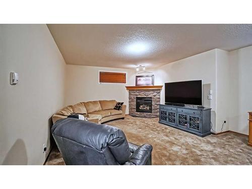 39 Panatella Crescent Nw, Calgary, AB - Indoor Photo Showing Living Room With Fireplace