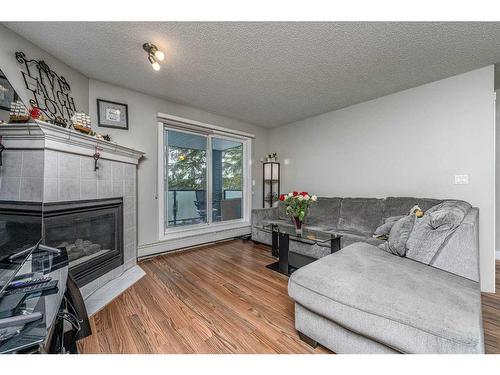 210-10 Sierra Morena Mews Sw, Calgary, AB - Indoor Photo Showing Living Room With Fireplace
