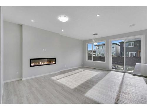 212 Seton Heath Se, Calgary, AB - Indoor Photo Showing Living Room With Fireplace
