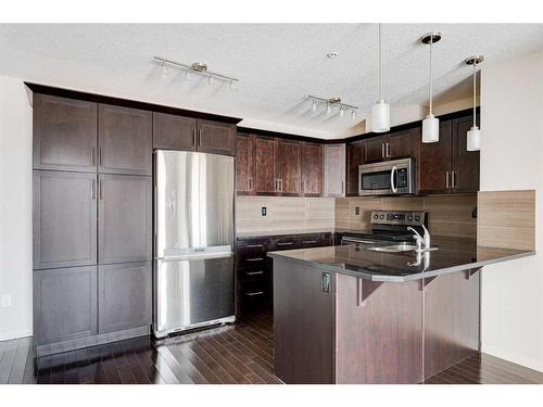 306-304 Cranberry Park Se, Calgary, AB - Indoor Photo Showing Kitchen With Stainless Steel Kitchen
