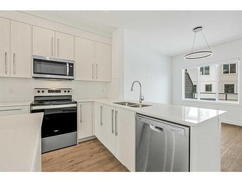 602-335 Creekside Boulevard Sw, Calgary, AB - Indoor Photo Showing Kitchen With Stainless Steel Kitchen With Double Sink