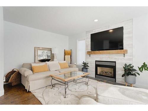 114 West Terrace Point, Cochrane, AB - Indoor Photo Showing Living Room With Fireplace