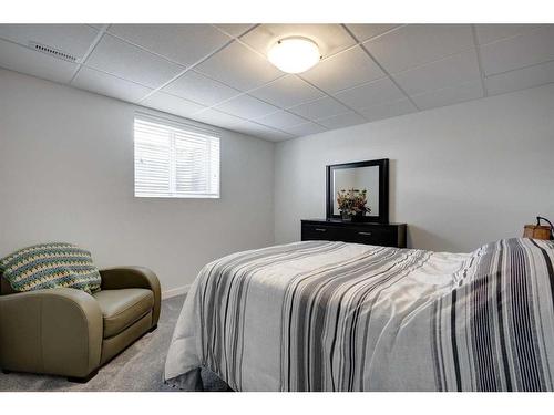 104 1 Avenue Se, Langdon, AB - Indoor Photo Showing Bedroom