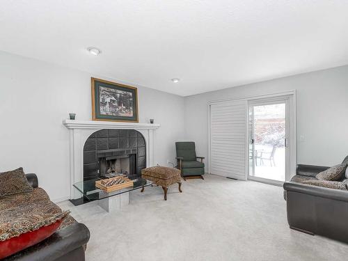 208 Millbank Road Sw, Calgary, AB - Indoor Photo Showing Living Room With Fireplace