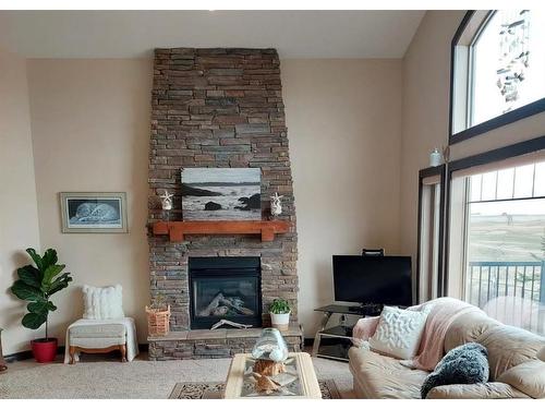627 Boulder Creek Drive Se, Langdon, AB - Indoor Photo Showing Living Room With Fireplace