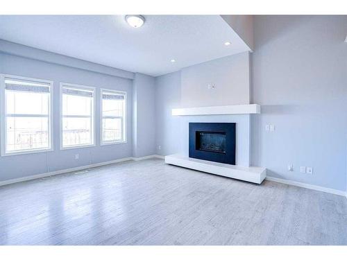 202 Reunion Green Nw, Airdrie, AB - Indoor Photo Showing Living Room With Fireplace