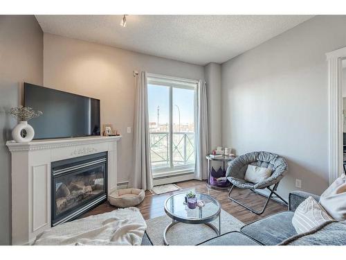 312-1507 Centre A Street Ne, Calgary, AB - Indoor Photo Showing Living Room With Fireplace