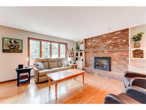 324 Coach Grove Place Sw, Calgary, AB - Indoor Photo Showing Living Room With Fireplace