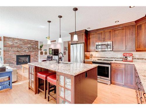 324 Coach Grove Place Sw, Calgary, AB - Indoor Photo Showing Kitchen With Fireplace With Upgraded Kitchen
