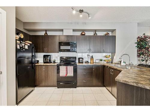 102-100 Cranfield Common Se, Calgary, AB - Indoor Photo Showing Kitchen With Double Sink