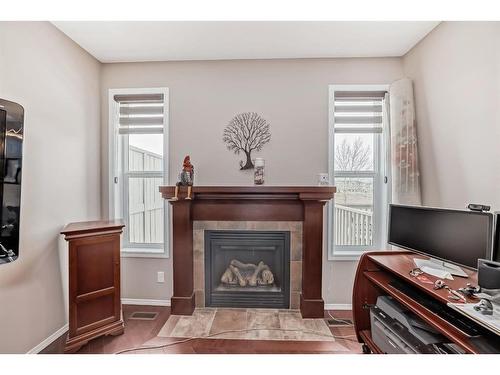 516 Panatella Square Nw, Calgary, AB - Indoor Photo Showing Living Room With Fireplace