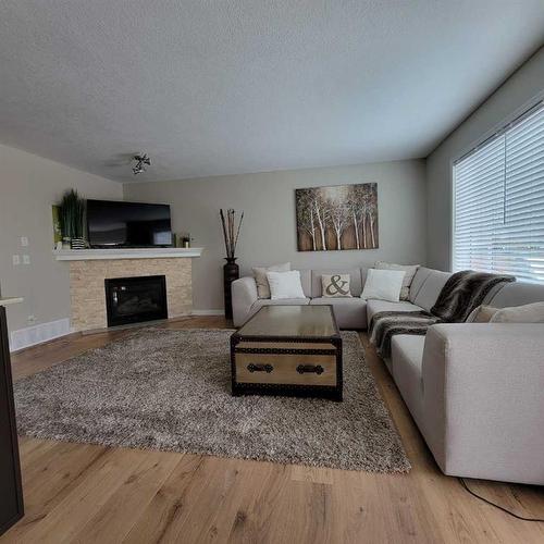 201 Tuscany Ravine Terrace, Calgary, AB - Indoor Photo Showing Living Room With Fireplace