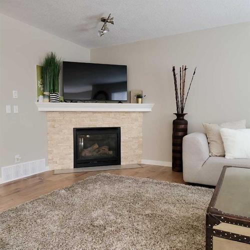 201 Tuscany Ravine Terrace, Calgary, AB - Indoor Photo Showing Living Room With Fireplace