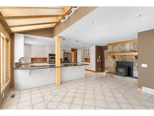 64 Mountain Lion Place, Bragg Creek, AB - Indoor With Fireplace